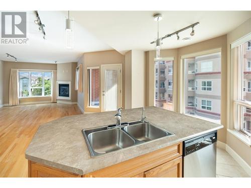 1947 Underhill Street Unit# 403, Kelowna, BC - Indoor Photo Showing Kitchen With Fireplace With Double Sink