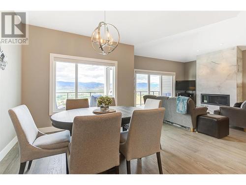 3950 Cimarron Drive, Kelowna, BC - Indoor Photo Showing Dining Room With Fireplace