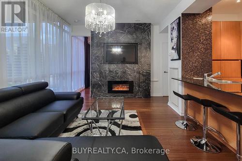 905 - 30 Canterbury Place E, Toronto, ON - Indoor Photo Showing Living Room With Fireplace