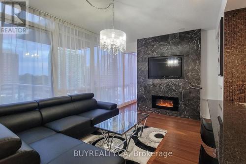 905 - 30 Canterbury Place E, Toronto, ON - Indoor Photo Showing Living Room With Fireplace