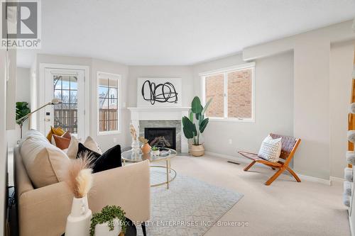 207 - 2055 Walkers Line, Burlington (Rose), ON - Indoor Photo Showing Living Room With Fireplace