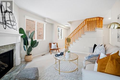 207 - 2055 Walkers Line, Burlington (Rose), ON - Indoor Photo Showing Living Room With Fireplace