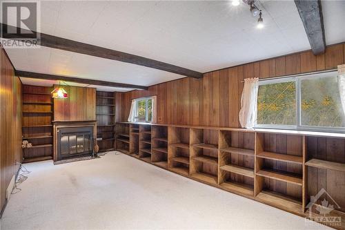 Lower level family room & wood burning fireplace - 1056 Harkness Avenue, Ottawa, ON - Indoor Photo Showing Other Room With Fireplace