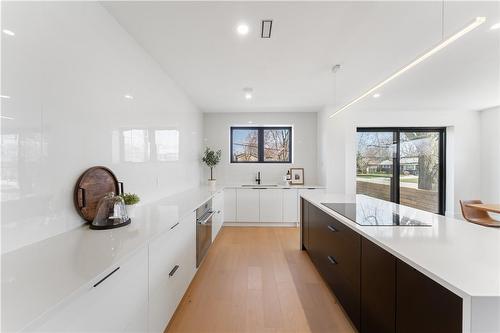 Kitchen with view to sliding doors. Steps down to private fenced patio - 5427 Anthony Place, Burlington, ON - Indoor Photo Showing Kitchen With Upgraded Kitchen