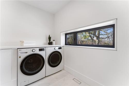 Laundry within spacious main bathroom. Heated floor. - 5427 Anthony Place, Burlington, ON - Indoor Photo Showing Laundry Room