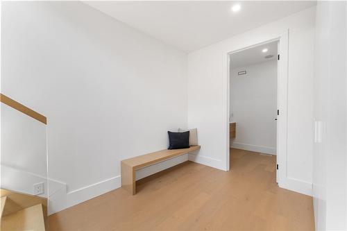 Mudroom. Built in bench. 2 huge double closets on right wall. Washroom. Glass stairway to upper level. - 5427 Anthony Place, Burlington, ON - Indoor Photo Showing Other Room