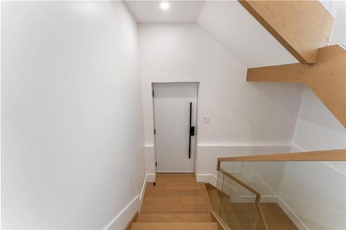 Stairway down to side door and lower level. White oak and glass. - 5427 Anthony Place, Burlington, ON - Indoor Photo Showing Other Room