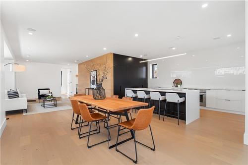 Open concept kitchen, dining, living. White oak flooring and feature wall. Speakers, pot lighting. - 5427 Anthony Place, Burlington, ON - Indoor Photo Showing Other Room