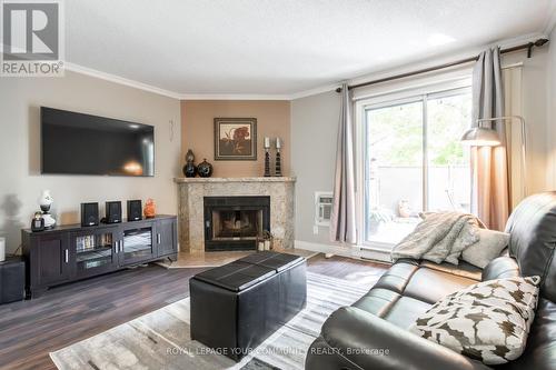 112 - 65 Trailwood Drive, Mississauga (Hurontario), ON - Indoor Photo Showing Living Room With Fireplace