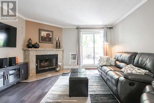 112 - 65 Trailwood Drive, Mississauga, ON - Indoor Photo Showing Living Room With Fireplace