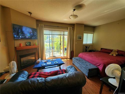 205-194 Beachside Dr, Parksville, BC - Indoor Photo Showing Bedroom With Fireplace