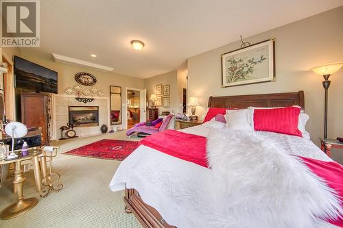 5090 Riverside  Drive, Fairmont Hot Springs, BC - Indoor Photo Showing Bedroom With Fireplace