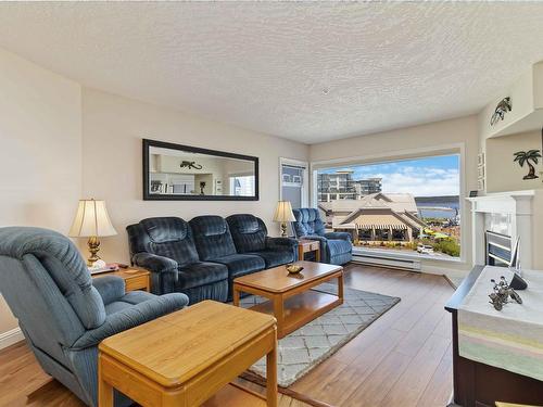 302-2550 Bevan Ave, Sidney, BC - Indoor Photo Showing Living Room With Fireplace