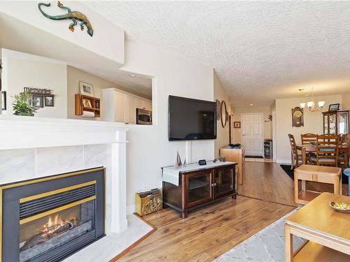 302-2550 Bevan Ave, Sidney, BC - Indoor Photo Showing Living Room With Fireplace