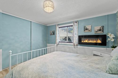 7251 45 Street, Salmon Arm, BC - Indoor Photo Showing Bedroom With Fireplace