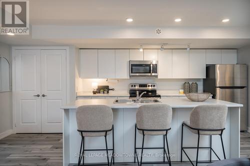 106 - 3058 Sixth Line, Oakville, ON - Indoor Photo Showing Kitchen With Stainless Steel Kitchen With Double Sink With Upgraded Kitchen