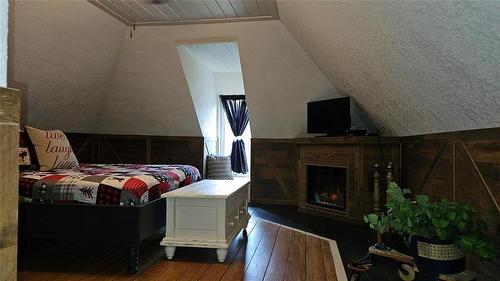 21 Government Road, Oak River, MB - Indoor Photo Showing Bedroom With Fireplace