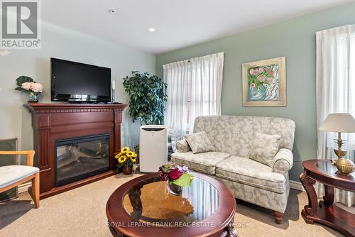 217 - 61 Clarington Boulevard, Clarington (Bowmanville), ON - Indoor Photo Showing Living Room With Fireplace