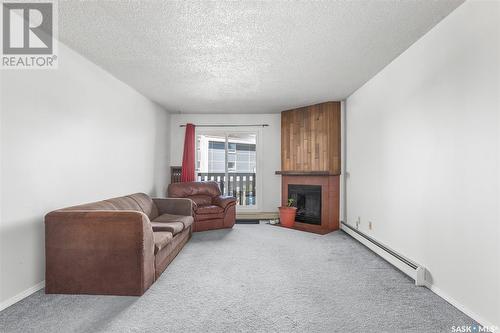 1420 425 115Th Street E, Saskatoon, SK - Indoor Photo Showing Living Room With Fireplace