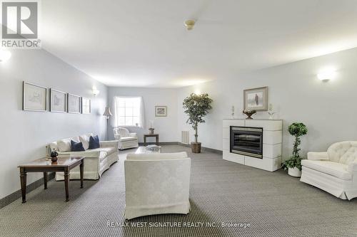 211 - 75 Treelawn Boulevard, Vaughan, ON - Indoor Photo Showing Living Room With Fireplace