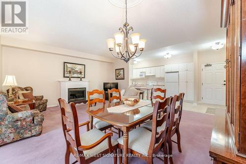 211 - 75 Treelawn Boulevard, Vaughan, ON - Indoor Photo Showing Dining Room With Fireplace