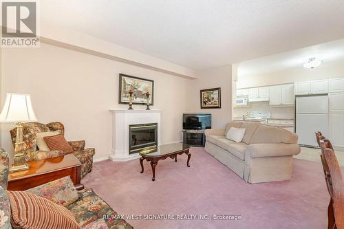 211 - 75 Treelawn Boulevard, Vaughan, ON - Indoor Photo Showing Living Room With Fireplace