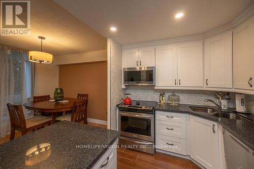 R1-1 - 60 Pavane Linkway, Toronto (Flemingdon Park), ON - Indoor Photo Showing Kitchen With Double Sink