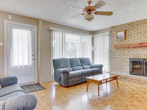 Salon - 8685 Av. Robert, Laval (Saint-François), QC - Indoor Photo Showing Living Room With Fireplace