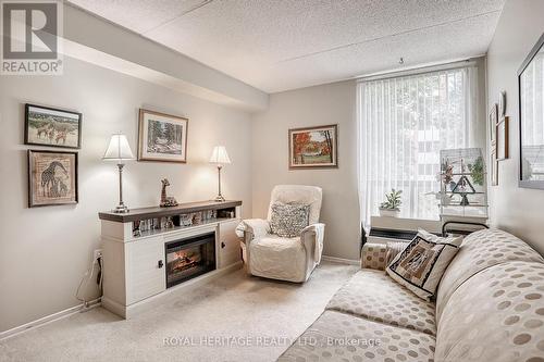 215 - 1525 Diefenbaker Court, Pickering (Town Centre), ON - Indoor Photo Showing Living Room With Fireplace