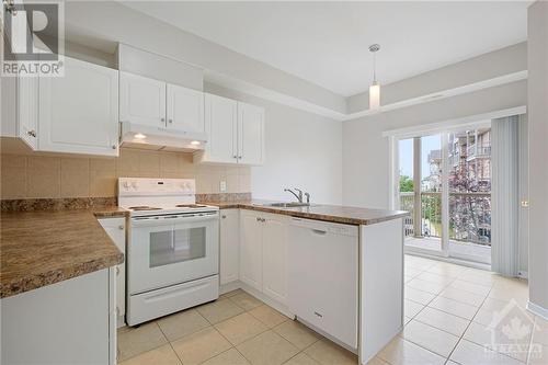 The bright white eat-in kitchen is adorned with plenty of cabinets, most of the appliances have been updated in 2020, & the fridge (2021). - 190 Rustic Hills Crescent Unit#6, Ottawa, ON - Indoor Photo Showing Kitchen