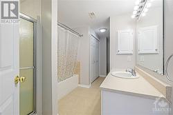 Main bath complete with a separate tub, standing shower, and the added benefit of in-unit laundry. - 