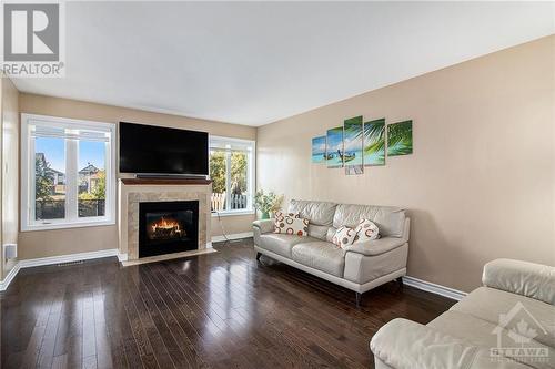 Living Room With Hardwood Flooring - 1831 Arrowgrass Way, Ottawa, ON - Indoor Photo Showing Living Room With Fireplace