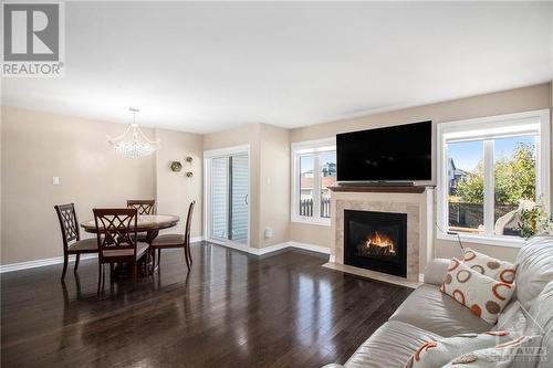 Dining Area Overlooking The Private Backyard - 1831 Arrowgrass Way, Ottawa, ON - Indoor Photo Showing Living Room With Fireplace