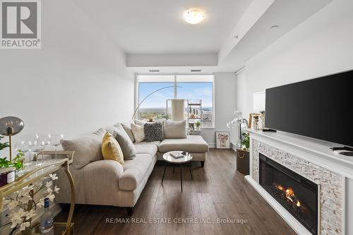 1210 - 2481 Taunton Road, Oakville (Uptown Core), ON - Indoor Photo Showing Living Room With Fireplace