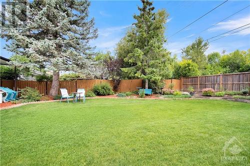 Note the surrounding flower beds. - 2536 Traverse Drive, Ottawa, ON - Outdoor With Backyard