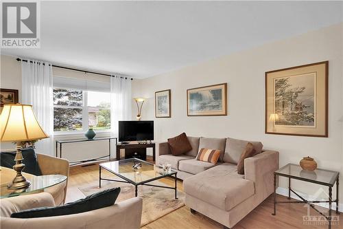 Living Room with refinished oak hardwood flooring and updated window.  Window coverings included. - 2536 Traverse Drive, Ottawa, ON - Indoor Photo Showing Living Room