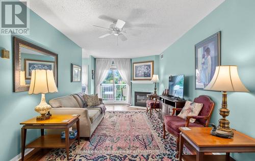 315 - 95 Wellington Street, Clarington (Bowmanville), ON - Indoor Photo Showing Living Room With Fireplace