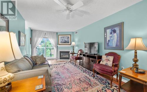 315 - 95 Wellington Street, Clarington (Bowmanville), ON - Indoor Photo Showing Living Room With Fireplace