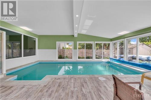 Patio doors all around open up for fresh air - 854 Explorer Lane, Ottawa, ON - Indoor Photo Showing Other Room With In Ground Pool