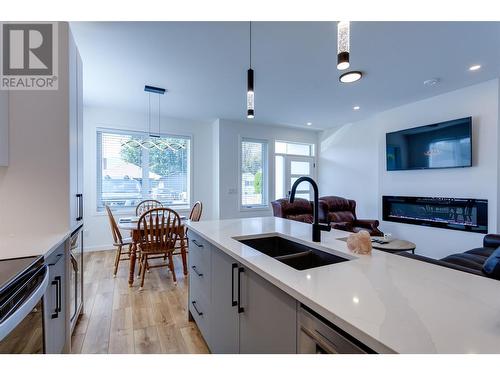 169 Maple Street Unit# 104, Penticton, BC - Indoor Photo Showing Kitchen With Fireplace With Double Sink