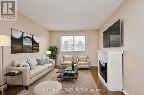 103 - 25 Meadow Lane, Barrie, ON - Indoor Photo Showing Living Room With Fireplace