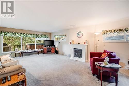 101 Cedar  Avenue, Fruitvale, BC - Indoor Photo Showing Living Room With Fireplace