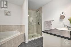 Spa-like ensuite bathroom with a corner tub and walk-in shower - 