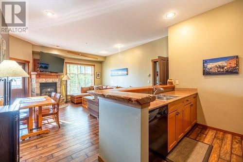 5258 Highline  Drive Unit# 119, Fernie, BC - Indoor Photo Showing Kitchen With Fireplace With Double Sink