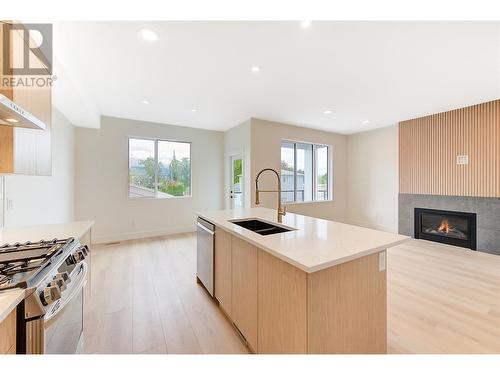 853 Kinnear Court, Kelowna, BC - Indoor Photo Showing Kitchen With Fireplace With Double Sink