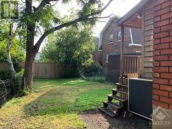 Side of yard with view of rear exit. - 