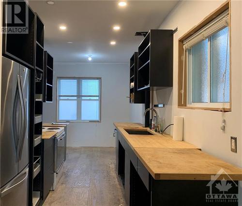 New IKEA kitchen - view from living room. Includes new stainless gas range/hoof fan and fridge. - 177 Hinton Avenue N, Ottawa, ON - Indoor Photo Showing Kitchen