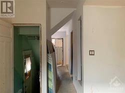 View from living room looking to basement and front hall. Powder room on the right is not visible. - 