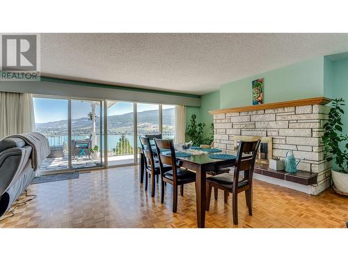 8209 Lakeview Drive, Coldstream, BC - Indoor Photo Showing Dining Room With Fireplace