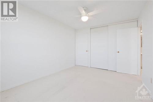 Primary Bedroom with good size closet plus a walk-in closet.  Note ceiling fan light. - 665 Bathgate Drive Unit#1401, Ottawa, ON - Indoor Photo Showing Other Room